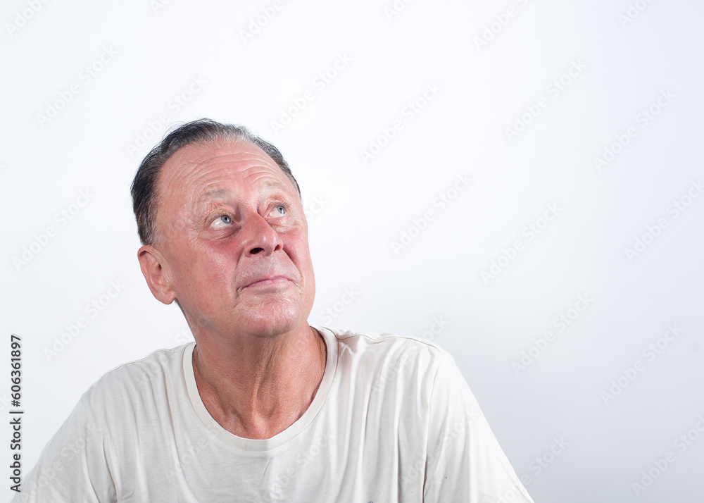 Serious middle-aged man thinking about things on isolated white background Serious middle-aged man thinking about things on isolated white background