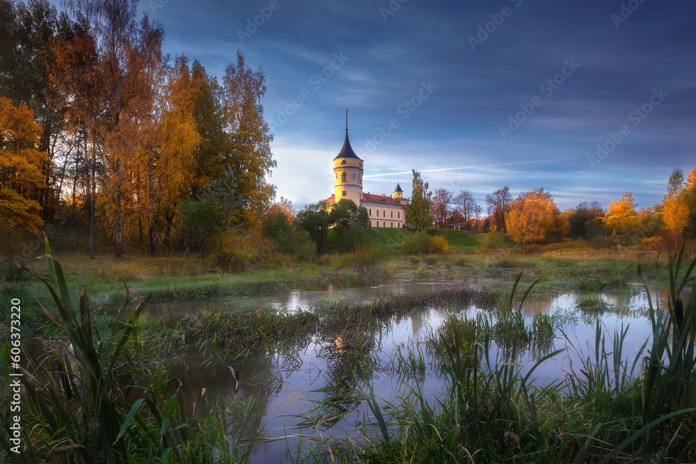 An autumn park on a sunny day with yellow leaves on trees and lawns An autumn park on a sunny day with yellow leaves on trees and lawns