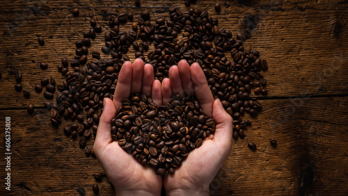 hands with coffee beans forming a heart. concept love for coffee