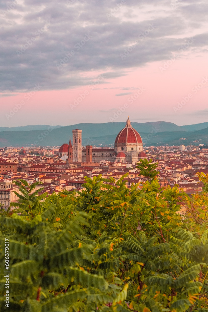 Panoramic view of Florence from Piazzale Michelangelo at pink sunrise. Cathedral of Santa Maria del Fiore and streets of an ancient Italian city.