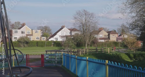 City park with children's play area and houses in the background, London, Bexley. photo