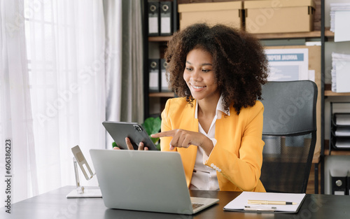 Happy black businesswoman using a tablet play social in a creative office.