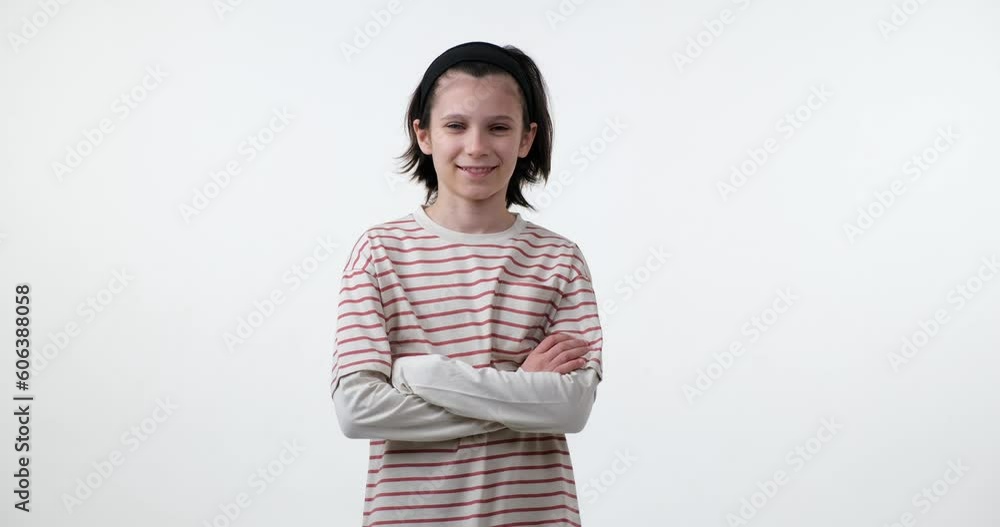 School-age boy standing on a white background, smiling and looking directly into the camera. The boy is dressed in casual clothing and has a friendly, approachable demeanor School-age boy standing on a white background, smiling and looking directly into the camera. The boy is dressed in casual clothing and has a friendly, approachable demeanor