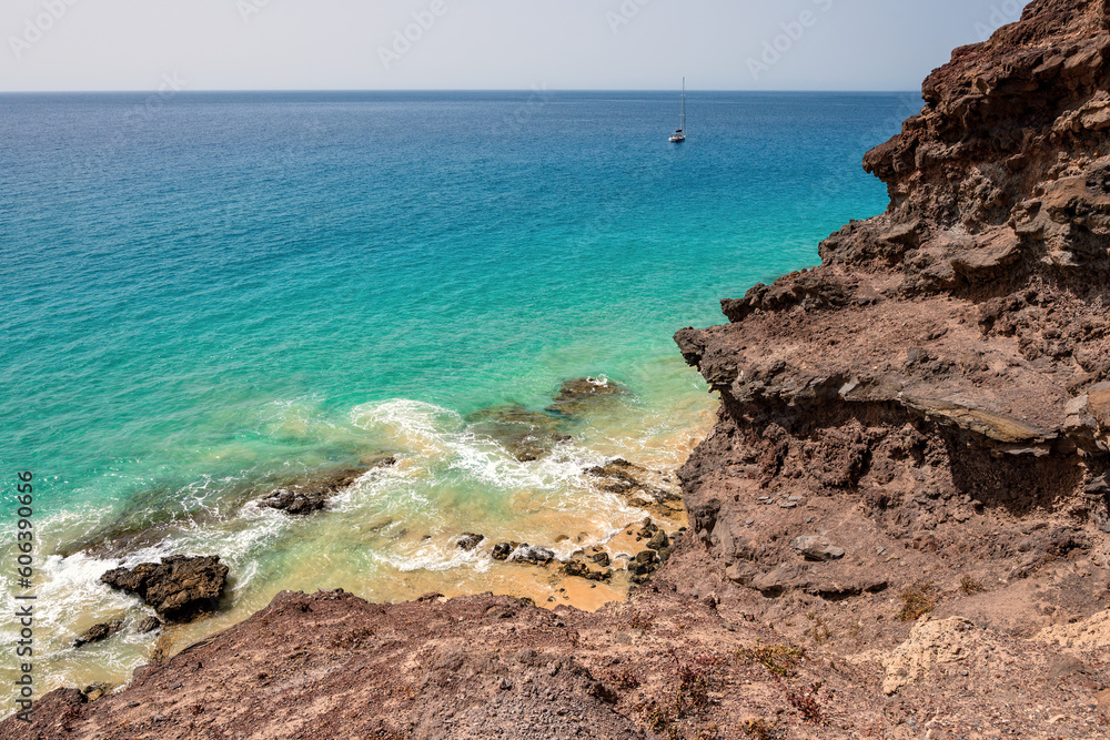 Rocks and sea. Rocky coast with the turquoise waters of the Atlantic Ocean. Fuerteventura, Canary Islands, Spain. Rocks and sea. Rocky coast with the turquoise waters of the Atlantic Ocean. Fuerteventura, Canary Islands, Spain.