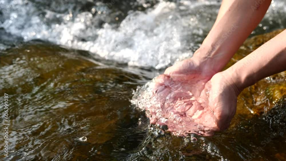Hands touching water in nature and life concept Hands touching water in nature and life concept