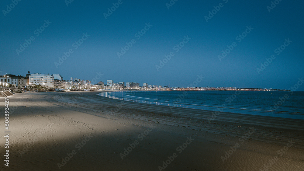 Les Sables-D'Olonne, view on the beach and city lights at sunset
