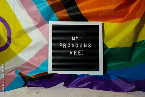 MY PRONOUNS ARE text Neo pronouns concept on Rainbow flag background gender pronouns. Non-binary people rights transgenders. Lgbtq community support assume my gender, respect pronouns tolerance equal photo