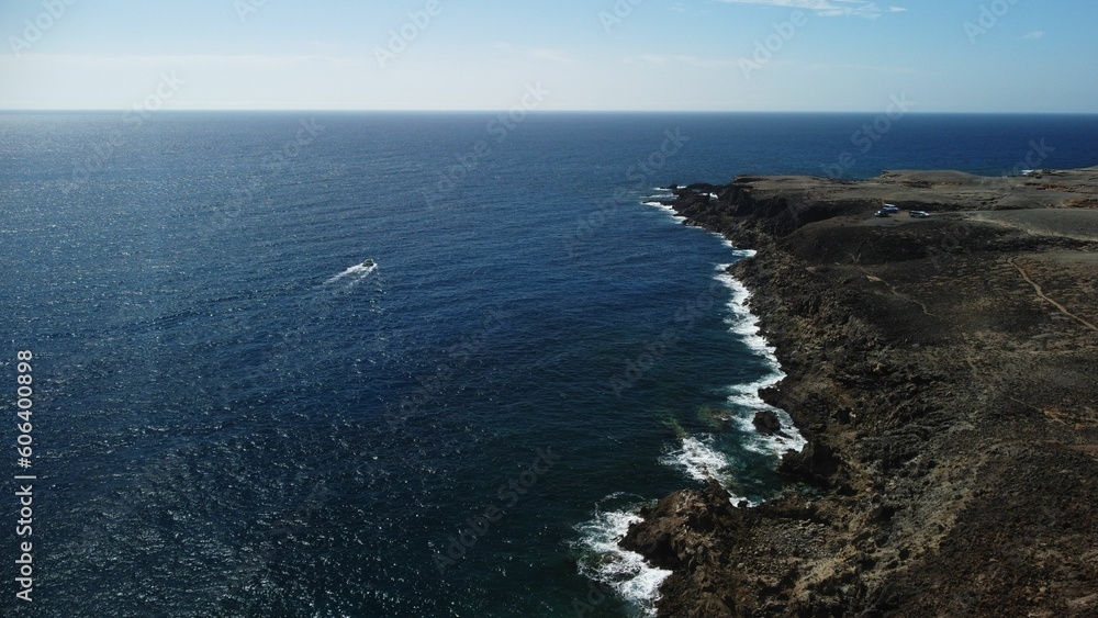 Aerial view of a boat sailing near the coastal Tenerife in Canary Islands of Spain Aerial view of a boat sailing near the coastal Tenerife in Canary Islands of Spain