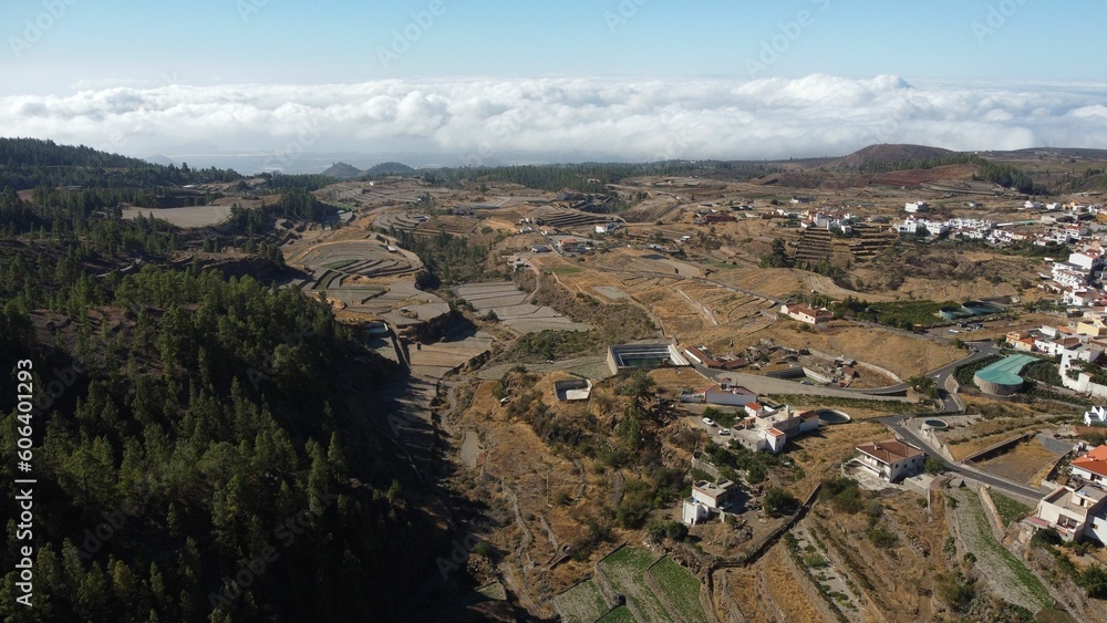 Aerial drone view of farmland and a forest outside Vilaflor town under a blue cloudy sky Aerial drone view of farmland and a forest outside Vilaflor town under a blue cloudy sky