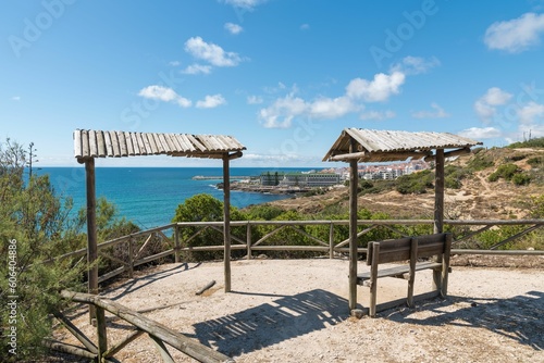 Beautiful view of the sea and city from a hill with wooden benches