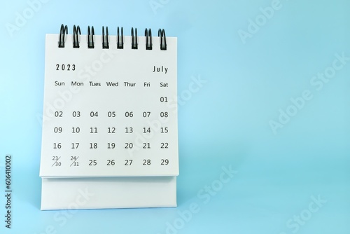 Obraz na płótnie Selective focus of July 2023 desk calendar on blue background with copy space. w salonie