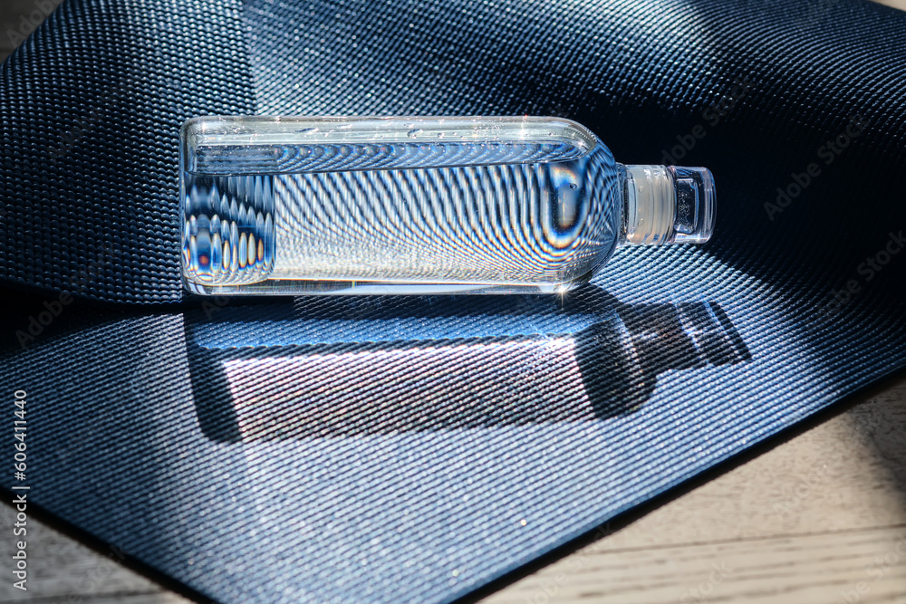 Reusable glass water bottle on yoga mat. Reusable glass water bottle on yoga mat.