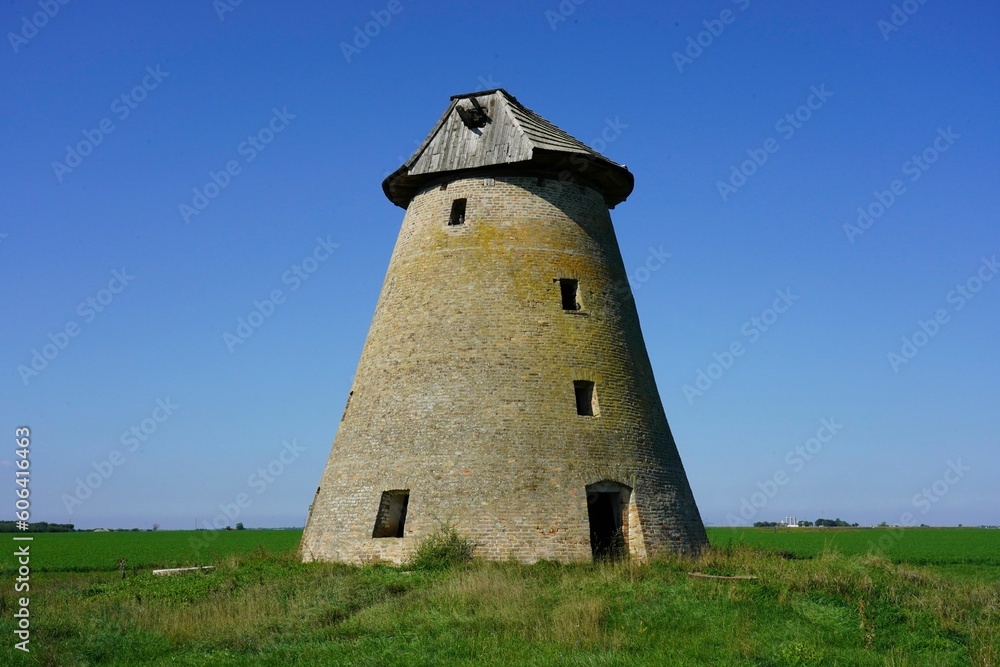 Medieval windmill building against clear blue sky Medieval windmill building against clear blue sky