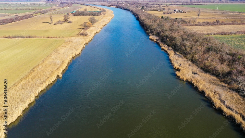 Beautiful view of the Danube-Tisa-Danube canal in the middle of agricultural field in Serbia Beautiful view of the Danube-Tisa-Danube canal in the middle of agricultural field in Serbia