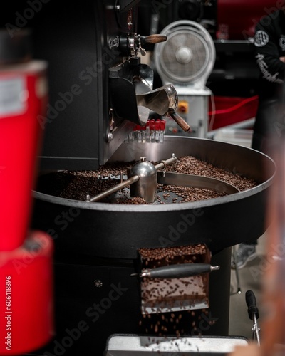 Vertical shot of the coffee roaster with coffee beans in a cafe