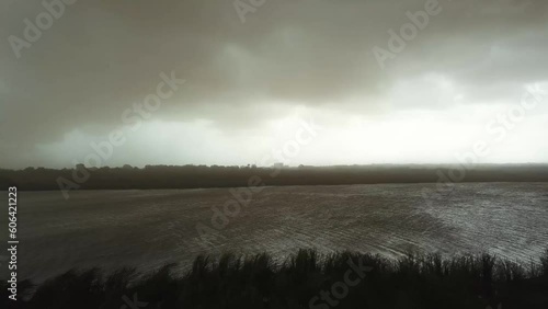 A tranquil body of water under storm clouds in East Legon Hills, Accra Ghana, West Africa photo