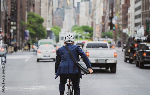 Salary workers are cycling in the city to work at rush hour.