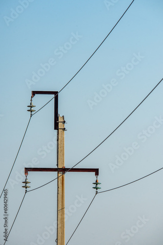 electric pole on a blue sky background, power transmission pole with green insulator