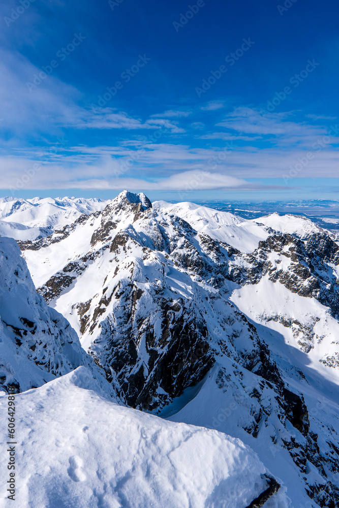 Beautiful winter scenery of Swinica and Beskid Peak from Kozi Wierch Peak in Tatras Mountains, famous place in Tatras with chalet. Poland. Tatra National Park