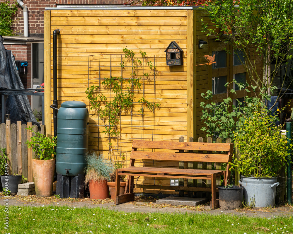 Rain barrel for rainwater harvesting and pot plants in the garden Rain barrel for rainwater harvesting and pot plants in the garden
