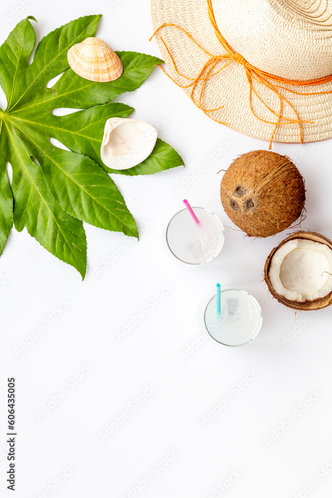 Fresh coconut milk cocktail in glasses with straw beach hat Fresh coconut milk cocktail in glasses with straw beach hat