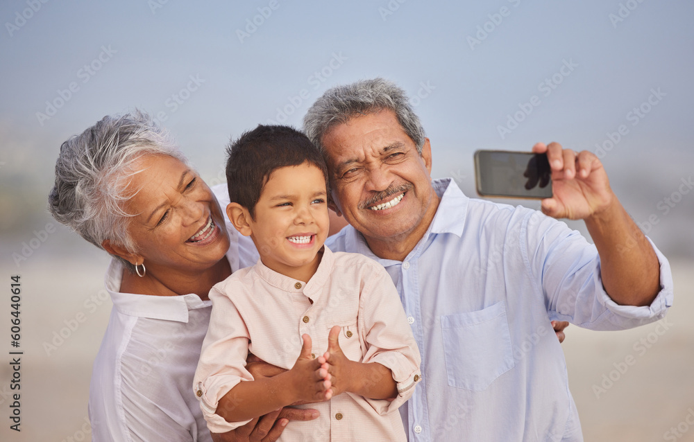 Selfie, happy and grandparents with child at beach for vacation, bonding and generations. Picture, travel and young boy with senior man and woman in nature for smile, happiness and technology Selfie, happy and grandparents with child at beach for vacation, bonding and generations. Picture, travel and young boy with senior man and woman in nature for smile, happiness and technology