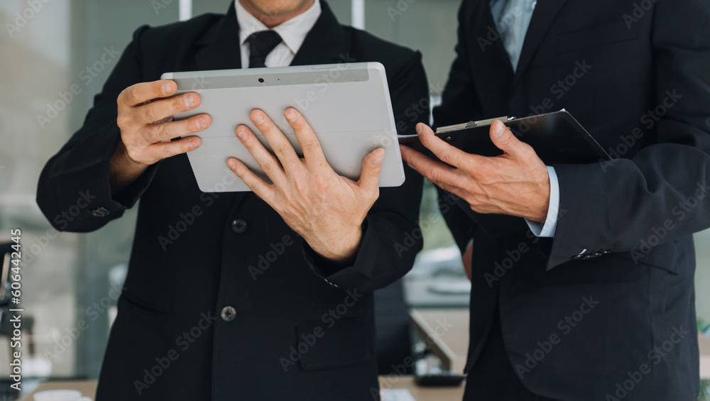 Financial analysts analyze business financial reports on a digital tablet planning investment project during a discussion at a meeting of corporate showing the results of their successful teamwork. Financial analysts analyze business financial reports on a digital tablet planning investment project during a discussion at a meeting of corporate showing the results of their successful teamwork.