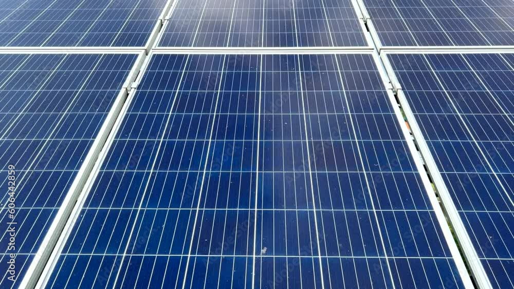 Closeup of surface of blue photovoltaic solar panels mounted on building roof for producing clean ecological electricity. Production of renewable energy concept Closeup of surface of blue photovoltaic solar panels mounted on building roof for producing clean ecological electricity. Production of renewable energy concept