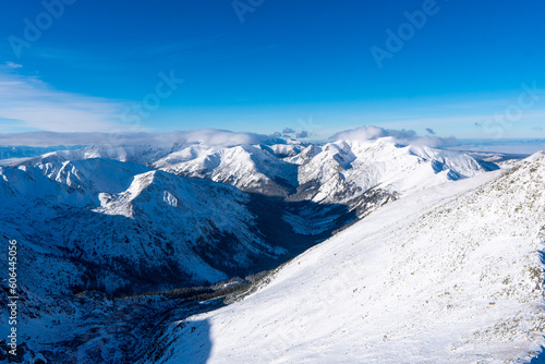 Beautiful winter scenery of Swinica and Beskid Peak from Kasprowy Wierch Peak in Tatras Mountains, famous place in Tatras with cable railway. Poland. Tatra National Park