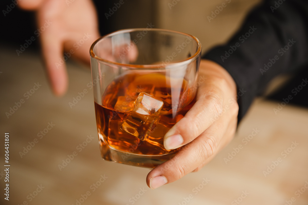 Young man holding whiskey glass in bar or restaurant. Young man holding whiskey glass in bar or restaurant.