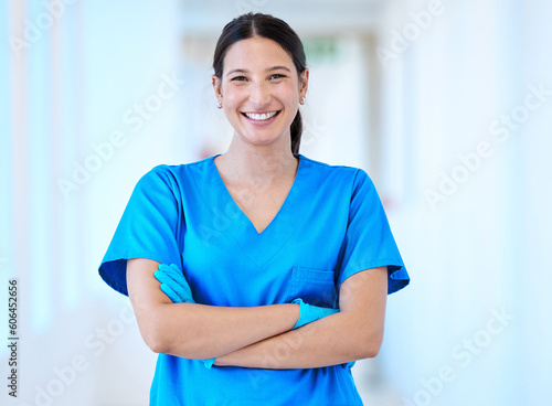 Woman, nurse and portrait with arms crossed and smile in a hospital and clinic. Employee, healthcare and wellness professional with happiness and confidence from doctor and medical work and care photo