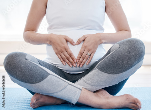 Fototapeta Naklejka Na Ścianę i Meble -  Woman, pregnant and yoga with lotus, floor or relax for health, exercise and wellness for body, mind and peace. Girl, pregnancy pilates and zen meditation with mindfulness in gym, studio or house