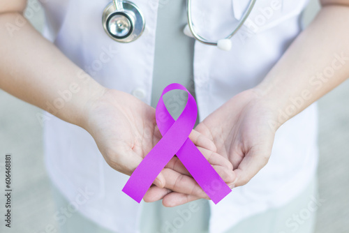 Purple awareness of ribbon in doctor hand for Cancer, ADD,ADHD,Alzheimer's Disease ,Arnold Chiari Malformation,Childhood Hemiplegia & stroke, Epilepsy, Chronic & Acute Pain,Crohns photo