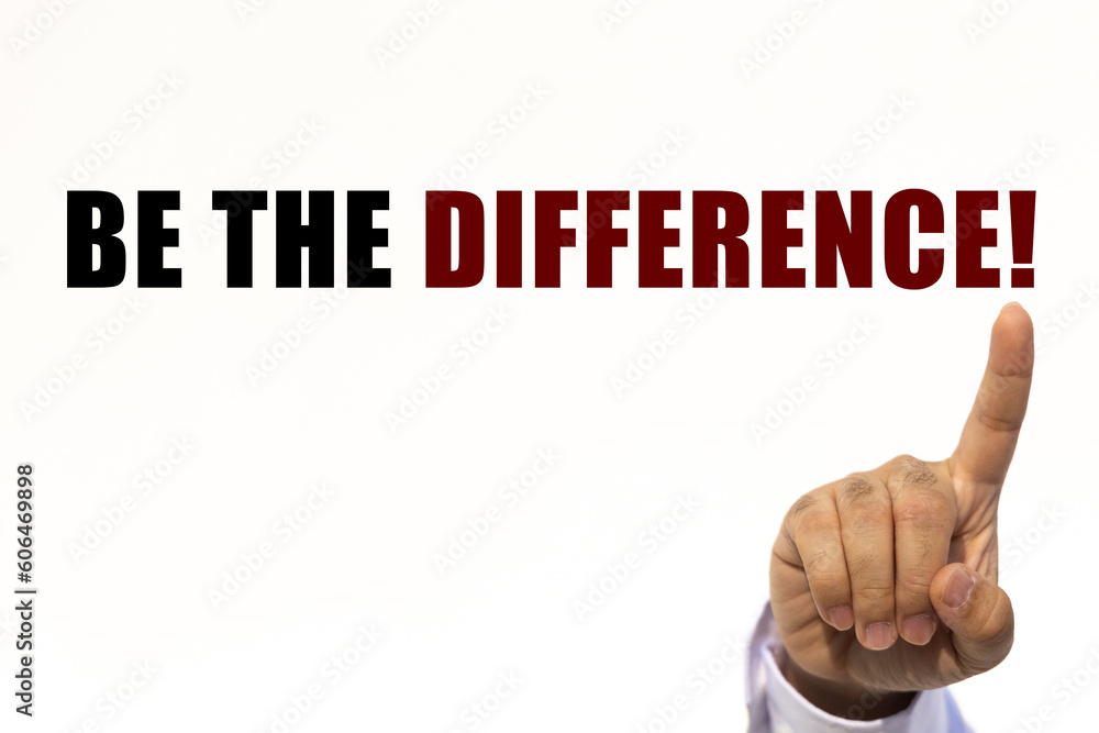 Be the difference text on white wall background with businessman's finger point at the message with empty space. This message can be used as business concept about being the difference. Be the difference text on white wall background with businessman's finger point at the message with empty space. This message can be used as business concept about being the difference.