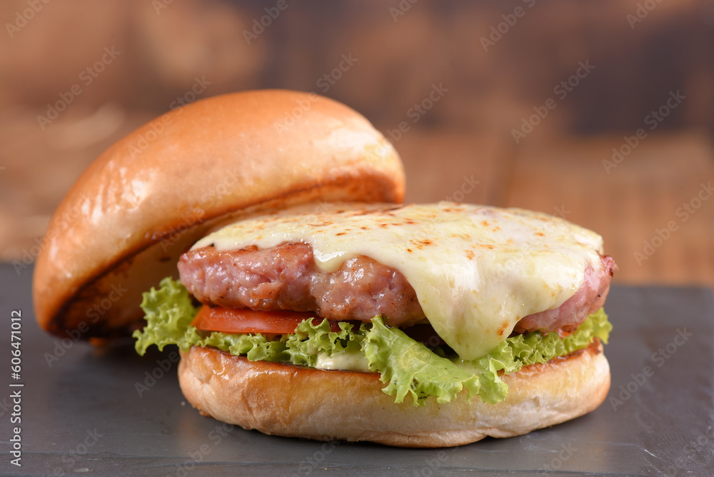 hamburger sandwich with melted cheese lettuce tomato mayonnaise and bread delicious fast food traditional snack hamburger sandwich with melted cheese lettuce tomato mayonnaise and bread delicious fast food traditional snack