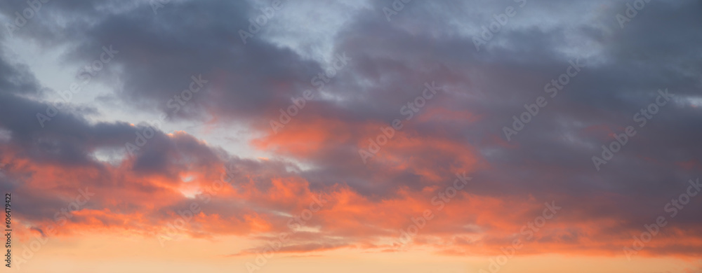 soft pastel colored sunset sky panorama with lighted clouds