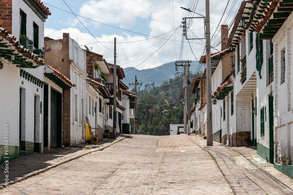 Typical street, with white colonial spanish facades, of the beautiful historical Colombian village Mongui ((Monguí), Boyaca, Colombia.