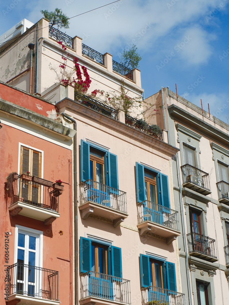 Classical vintage facades with colourful windows and balconies downtown Cagliari, Sardinia island, Italy. Vertical photo
