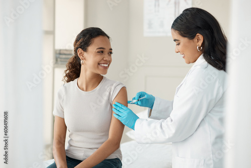 Injection, vaccine and patient at the clinic for consulting and help with prevention with a smile. Doctor, inject and woman on arm for virus with gloves in medical room for wellness or health. photo