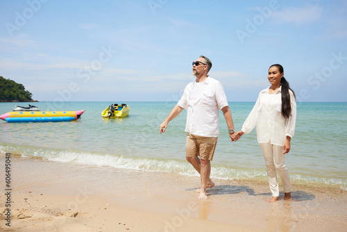 couple walking and looking to sky on the beach