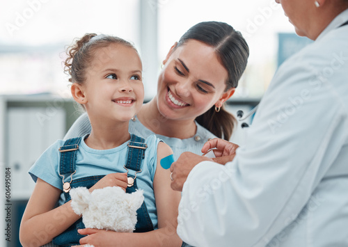 Girl, mom and doctor with vaccine injection, cotton ball and flu shot on arm for disease or covid prevention in hospital. Woman, nurse and child with pediatrician help with bandaid, teddy or health