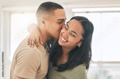 Couple, love and kiss in home for happy romance, intimacy and relax while bonding together. Young man, woman and kissing partner in relationship, quality time and smile for care, trust and happiness © Kirsten D/peopleimages.com