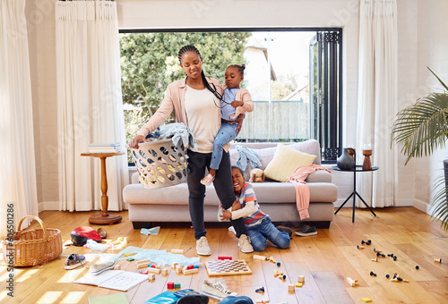 Toys, children and mother with stress, laundry and home with tantrum, messy living room and anxiety. Family, mama and kids with housekeeping, burnout and mental health issue with untidy living room