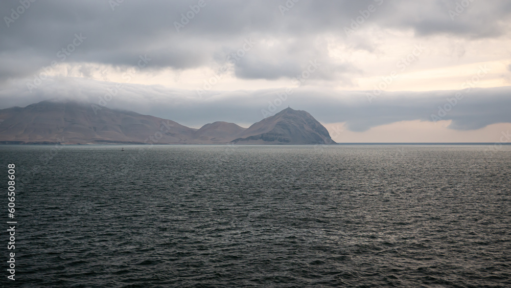 View of Isla San Lorenzo Island near Callao Peru during evening with clouds on the sky and waves on the sea