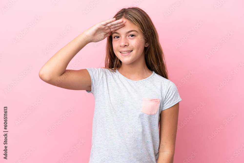 Little caucasian girl isolated on pink background saluting with hand with happy expression Little caucasian girl isolated on pink background saluting with hand with happy expression
