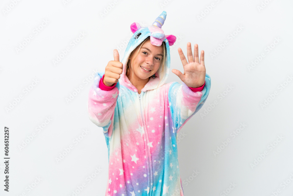 Little girl with unicorn pajamas isolated on white background counting six with fingers Little girl with unicorn pajamas isolated on white background counting six with fingers