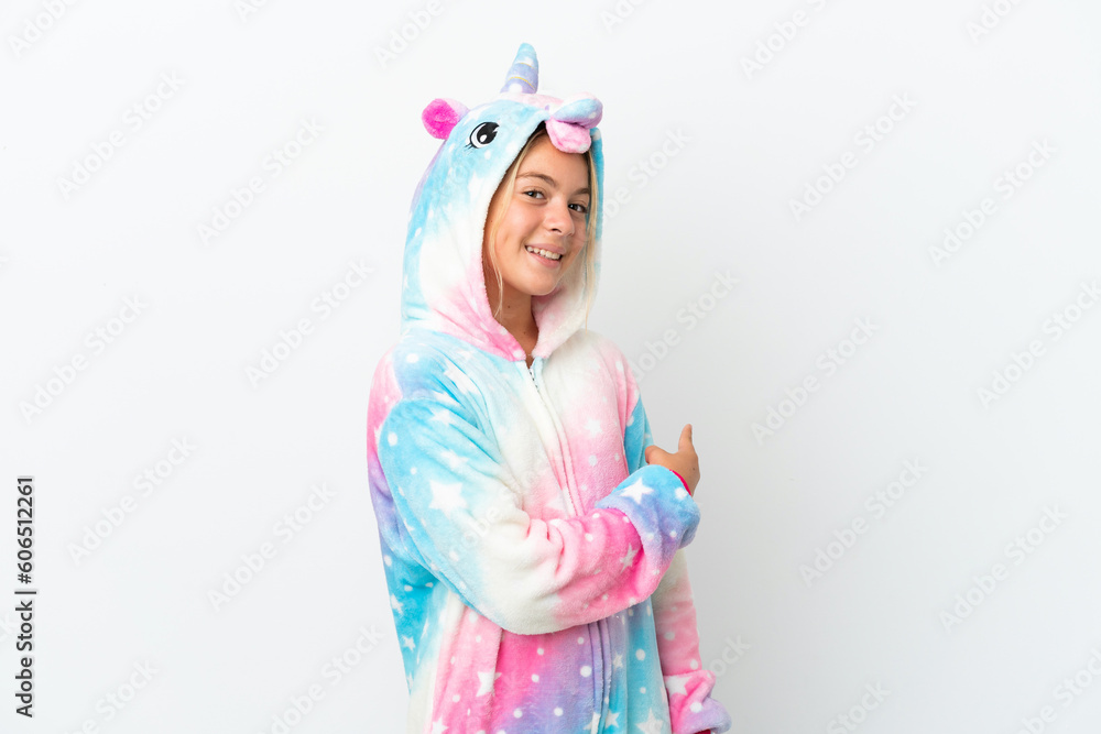 Little girl with unicorn pajamas isolated on white background pointing back Little girl with unicorn pajamas isolated on white background pointing back