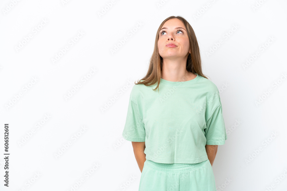 Young Lithuanian woman isolated on white background and looking up Young Lithuanian woman isolated on white background and looking up