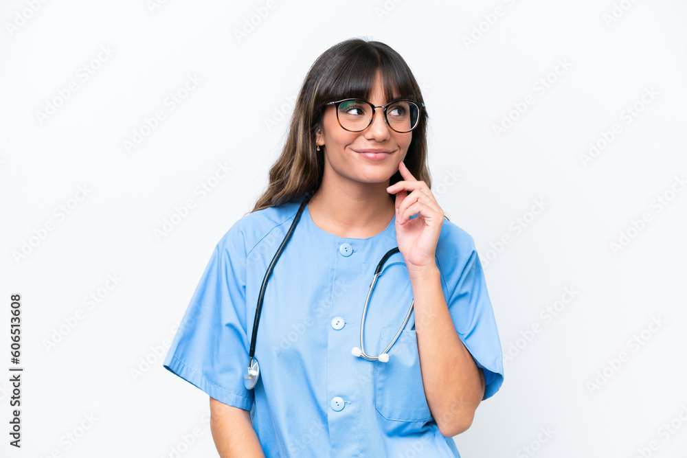 Young caucasian nurse woman isolated on white background thinking an idea while looking up Young caucasian nurse woman isolated on white background thinking an idea while looking up