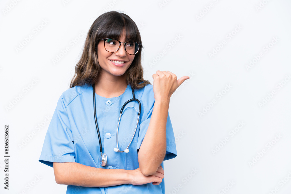 Young caucasian nurse woman isolated on white background pointing to the side to present a product Young caucasian nurse woman isolated on white background pointing to the side to present a product